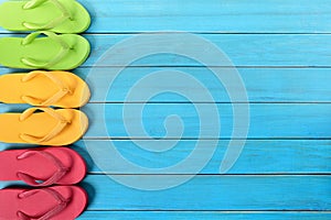 Side border row of flip-flops on blue background wood beach deck