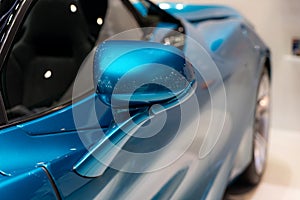 Side car mirror close-up. Details of blue car. Empty side rear view mirror concept with copy space
