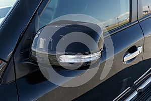 Side car mirror close-up. Details of luxury car. Car detail. Exterior details. Automotive concept