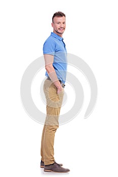 Side of casual young man with hand in pocket