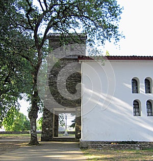 Side of the Chapel of Santa Maria de Deixebre, with cruceiro in the background photo
