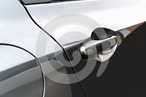 The side door of the black car Used as a handle to open the door.