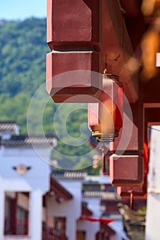Side exterior of tall traditional Chinese architecture facade temple with red walls under blue sky