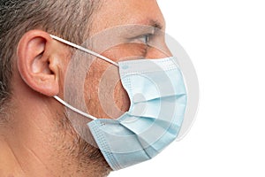 Side face head view of man wearing medical surgical disposable mask