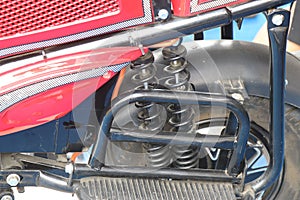 Side frames made of metal with suspension to absorb shocks added behind an electric vehicle