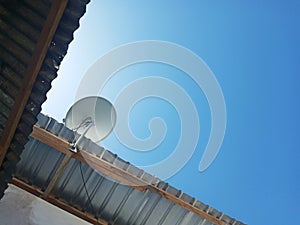 Side of A House Building with TV Antena and Clear Blue Sky Backgroung