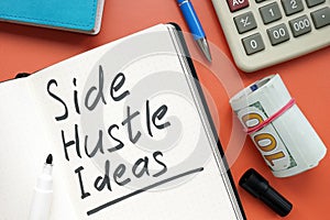 Side hustle ideas list and cash on the desk.