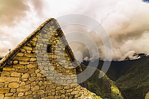 Side of an Inca building with trapezoidal window in Machu Picchu