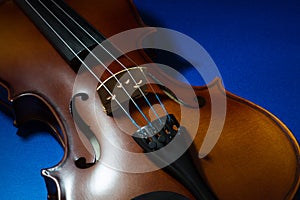 Side Lit Violin Body on a Blue Surface