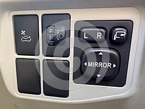 Side mirrors control panel of a car to adjust the side mirror, headlights and air recirculation