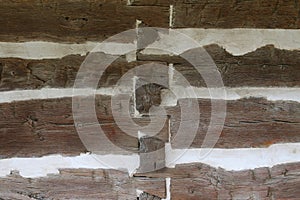 Side of an old cabin showing chinking