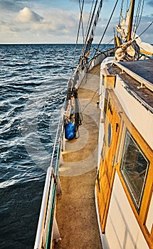 Side of an old sailing schooner at sunset
