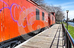 Side of a orange Caboose train