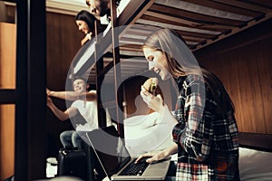 Side photo of Girl eating hamburger in Hostel