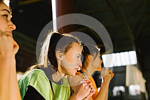 A side photo of three teammates, restless and focused, holding their fists for their team& x27;s victory. Strength and