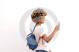 Side portrait of african american female looking at smart phone against white background