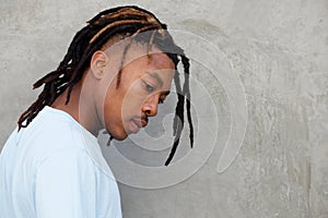 Side portrait of african man with dreadlocks in contemplation photo