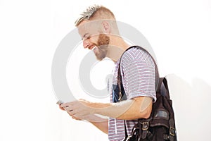 Cool young guy with beard looking at mobile phone
