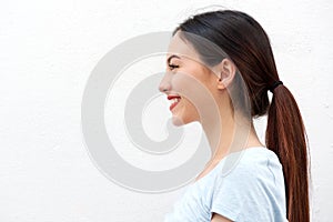 Side portrait of healthy young woman with long hair smiling