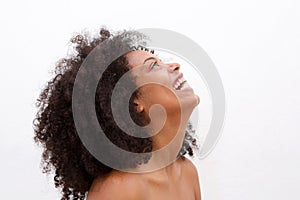 Side portrait of laughing black woman with bare shoulders