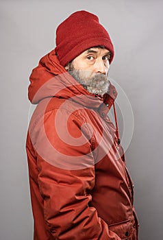 Side portrait of man in winter coat freezing in the cold