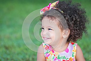 Side portrait of a small hispanic girl with an afro hairstyle