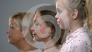 Side portrait of three female generations, birthrate and population ageing