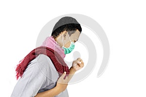 Side portrait of unidentified sick man coughing