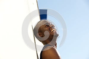 Side portrait of young black man laughing photo