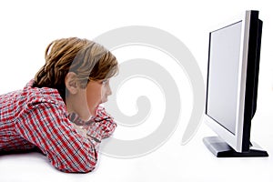 Side pose of boy watching lcd screen
