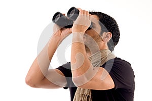 Side pose of man looking through binocular