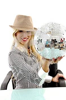 Side pose of smiling woman holding disco ball