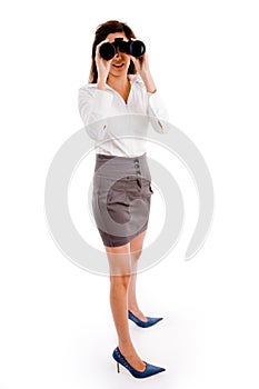 Side pose of woman looking through binocular