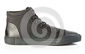 Side profile of black sneaker close-up isolated on a white background