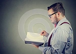 Side profile of a business man reading a book