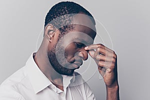 Side profile close up view portrait of nervous stressed depressed unsatisfied hard-working african man with closed eyes touching