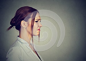 Side profile disgusted annoyed young woman photo