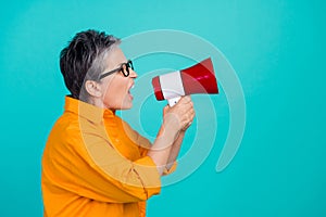 Side profile photo of aggressive business woman screaming bossy holding megaphone look copyspace isolated on cyan color