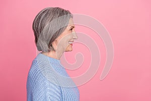 Side profile photo of mature aged old senior cheerful grandmother woman gray hair smiling looking empty space ad