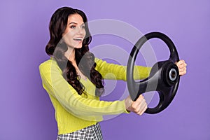 Side profile photo portrait of brunette woman keeping steering wheel driving car isolated on pastel purple color