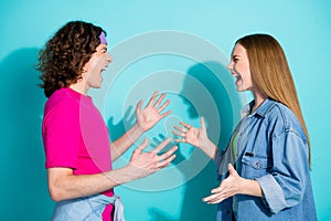 Side profile photo of young sister and brother teen age has conflict dialogue screaming at each other isolated on cyan