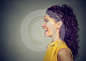 Side profile portrait of a happy laughing woman