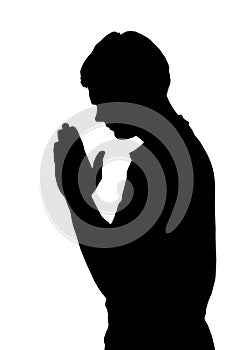 Side profile portrait silhouette of religious teenage boy praying