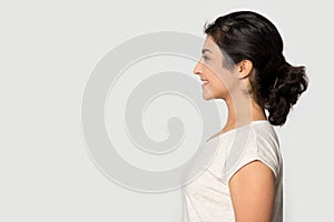 Side profile view indian ethnicity girl looking at empty copyspace.