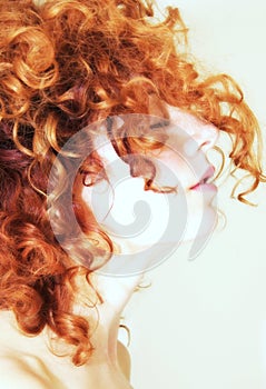 Side profile of woman with curly red hair