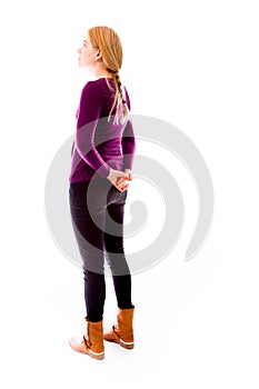 Side profile of a young woman thinking with hands behind back
