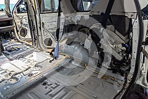The side rear element of the cab inside the SUV car, dismantled trim, prepared for the replacement and installation of noise