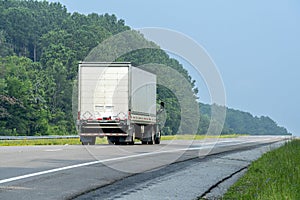 Side-Rear View of Eighteen Wheeler Going Down The Interstate