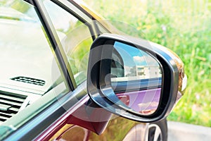 Side rear-view mirror on car