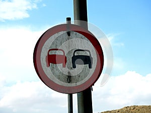 A side road board traffic sign to prohibit passing, no passing zone, no overtaking, do not pass vehicle zone, dangerous driving